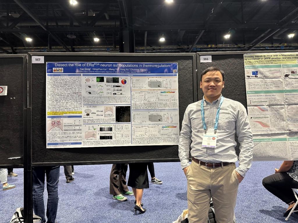 man standing near a poster at the 2024 SfN