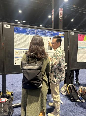 people looking at a poster at the 2024 SfN