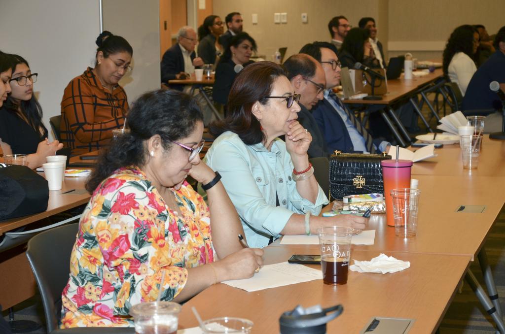 people sitting at desks, taking notes