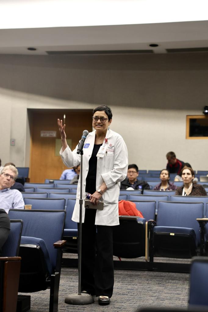 person standing at a microphone speaking
