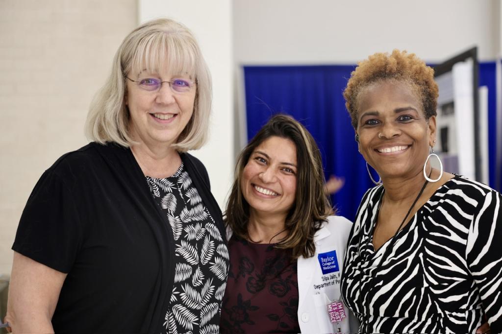3 people standing together smiling