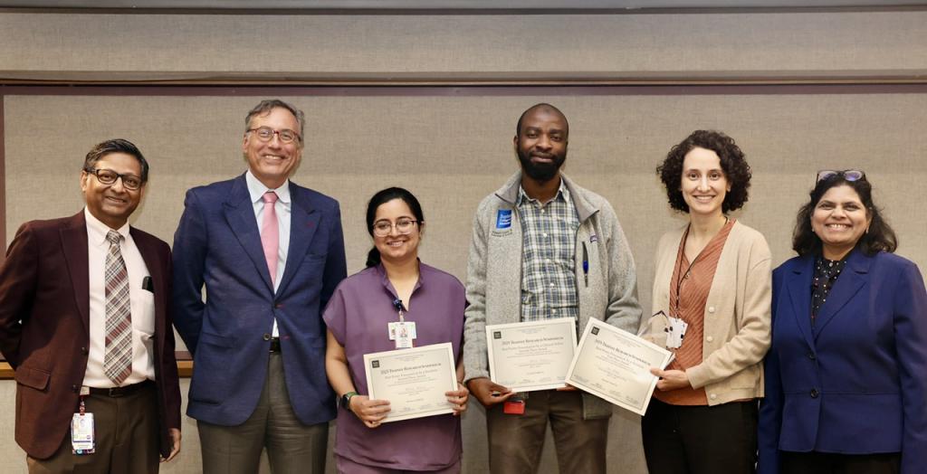 small group of people smiling and holding certificates