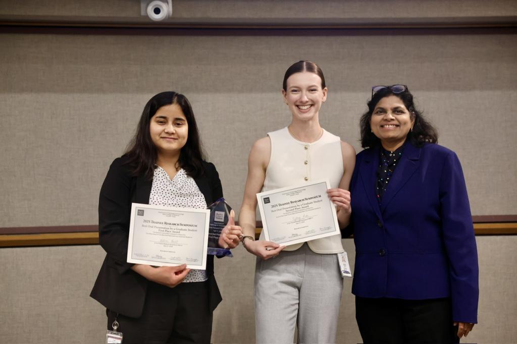 3 people standing together smiling and holding certificates