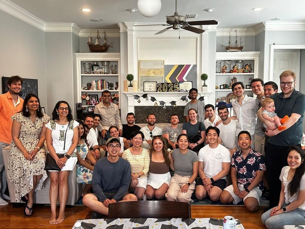 a large group of people in a living room smiling