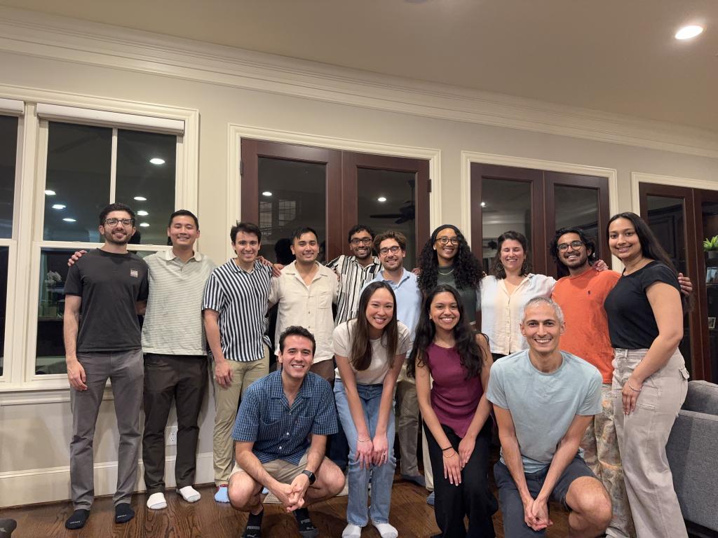 a group of people in a house smiling