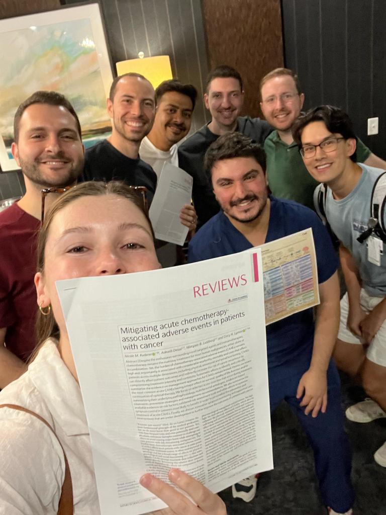 group of people holding a piece of paper and smiling