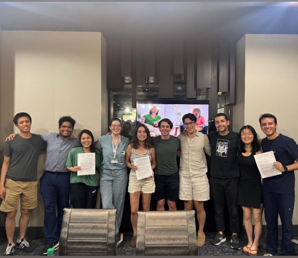 people holding pieces of paper and smiling