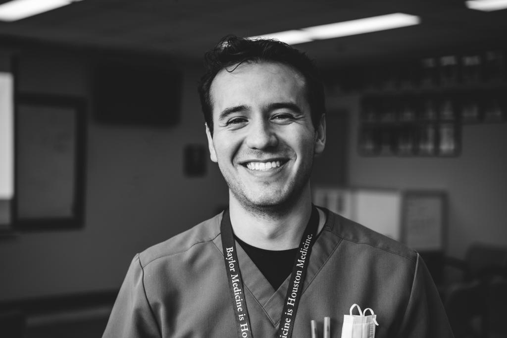 a black and white photo of a man smiling