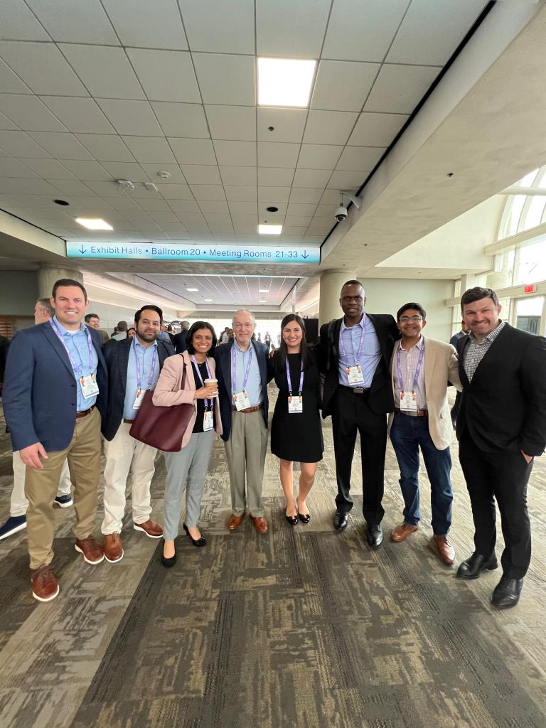 people in business attire smiling and wearing name tags