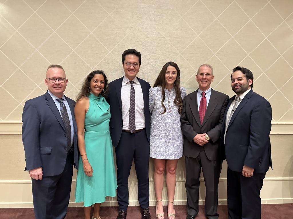 6 people standing together, smiling