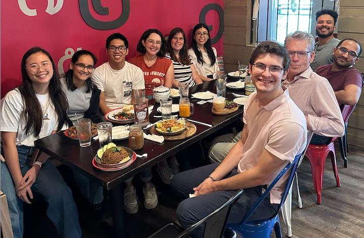 people smiling at a dinner table