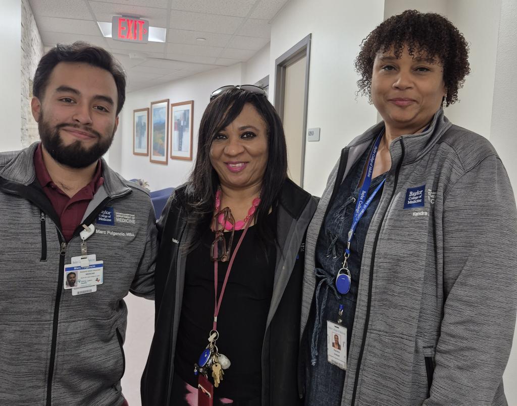 3 people standing together, smiling