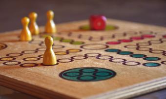 Close up photo of a board game with wooden game pieces 