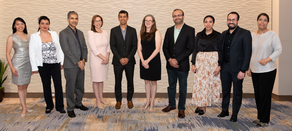 Faculty members pose in a line