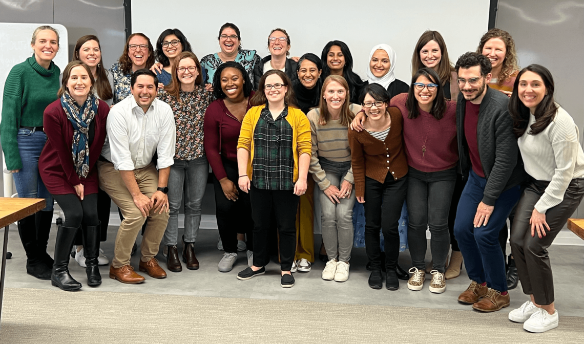 A large group of fellows pose in a photo studio