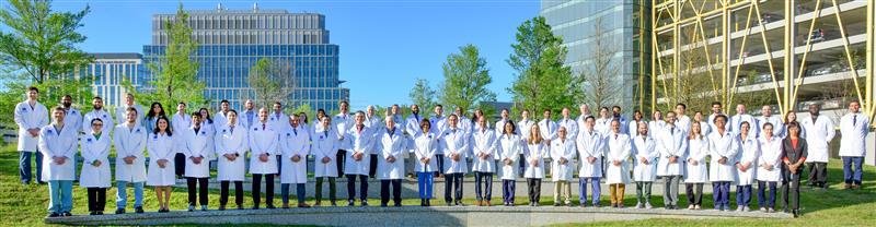 group of doctors in white coats smiling