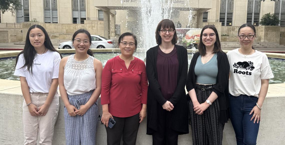 women standing in front of a fountain