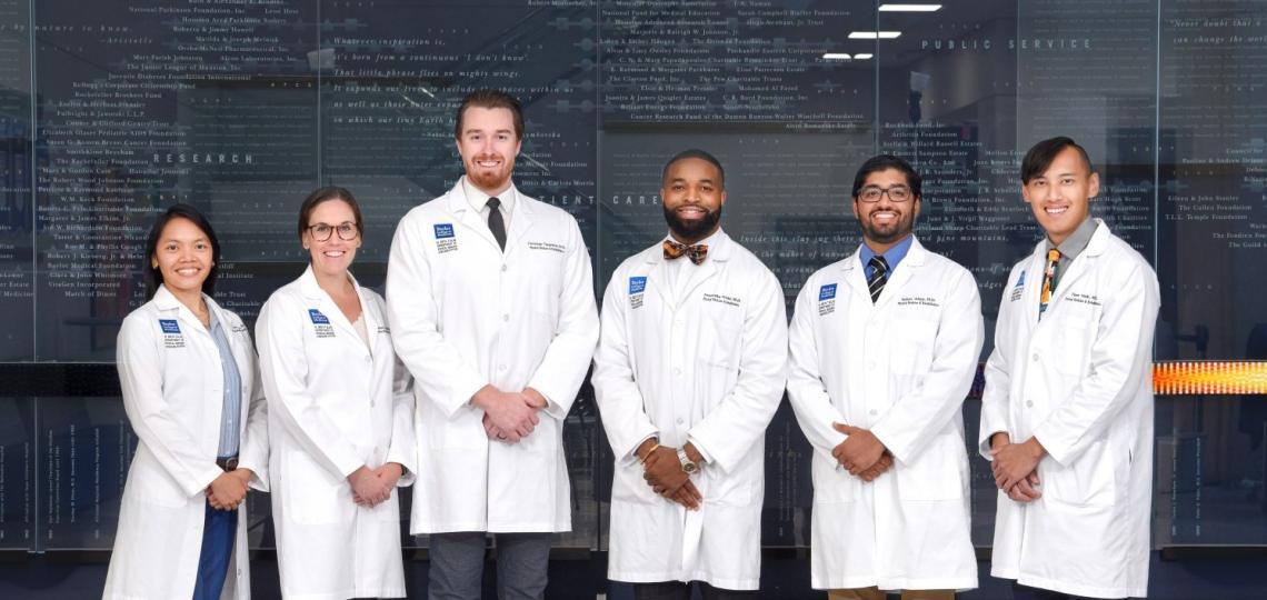 group of doctors in white coats smiling