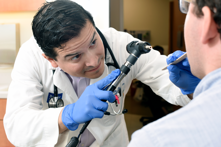 A doctor examines a patient.