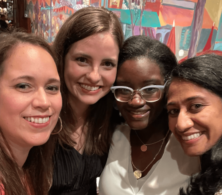 Pediatric Critical Care Fellowship members pose head-to-head while smiling during an event