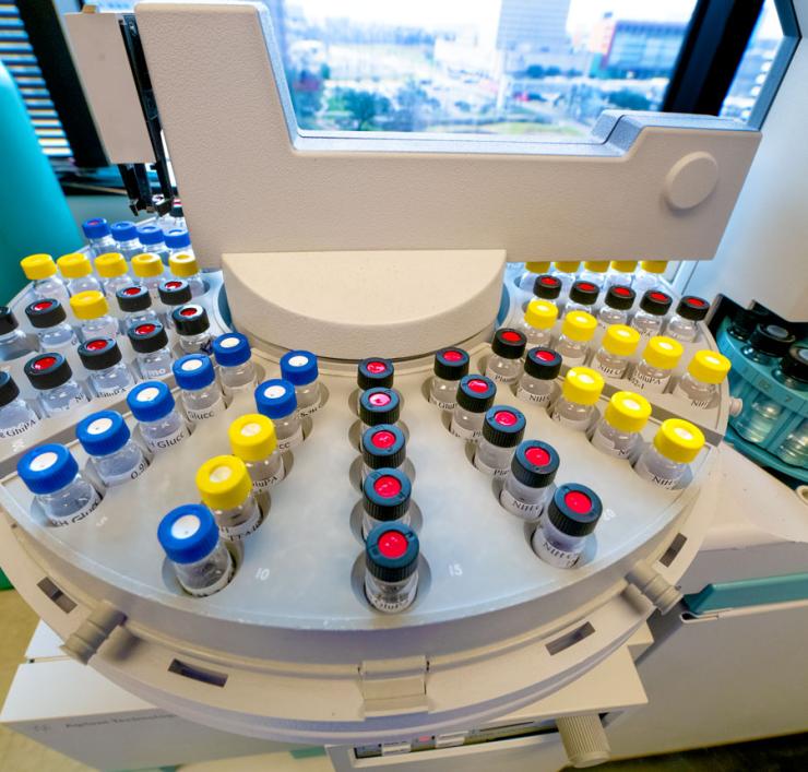 Samples of stable isotopes, lined up in bottle with red, yellow and black caps.