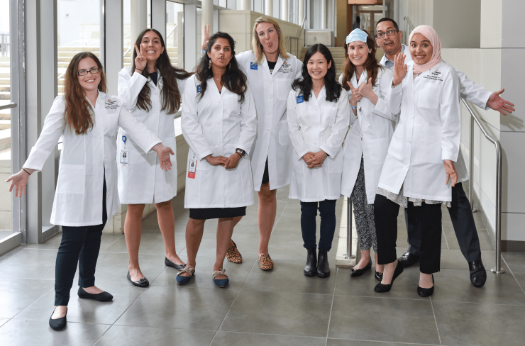 Several fellows doing a group picture in silly poses