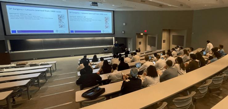 A group in a lecture room listening to speeches