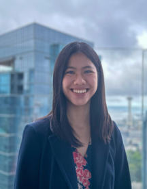 Photo of woman in front of a city skyline