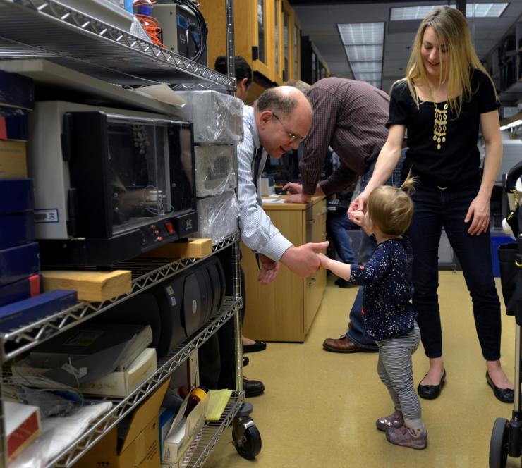 Phot of Dr. Edward Cooper meeting Harper and her parents in his lab in 2014. 