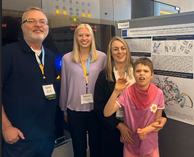 Scotty Sims (R) and family meet with BCM researchers for a poster presentation related to her daughters condition in 2023.