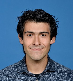 Man smiling in front of blue background