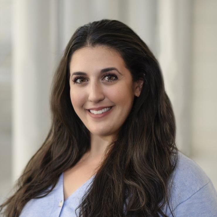 woman in lavender top with long dark hair smiling