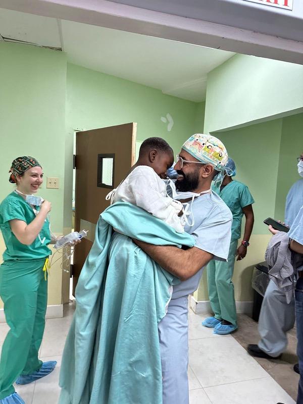 doctor holding a child smiling