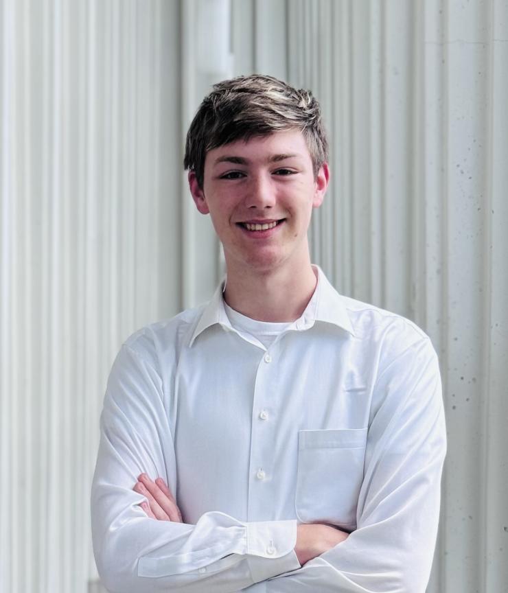 man smiling in front of grey background