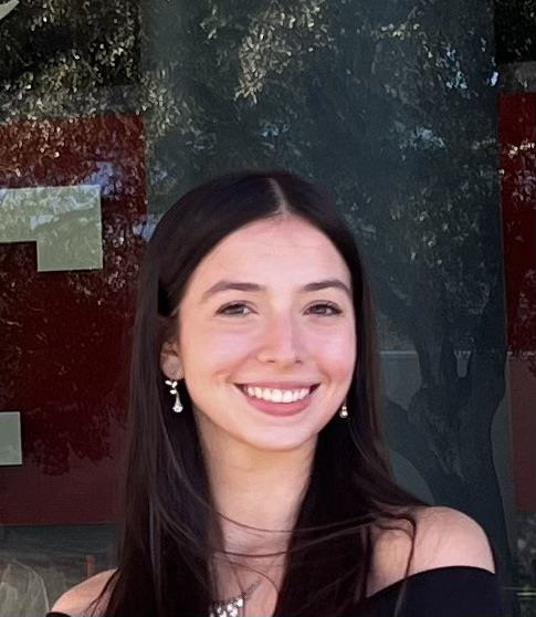 Woman smiling in front of grey background