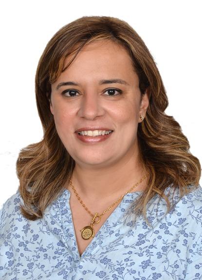 woman with a floral blue top on smiling