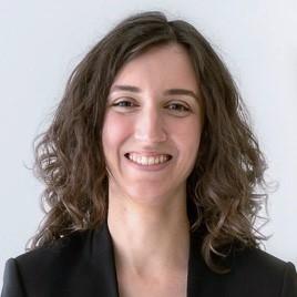 woman with curly shoulder length hair smiling