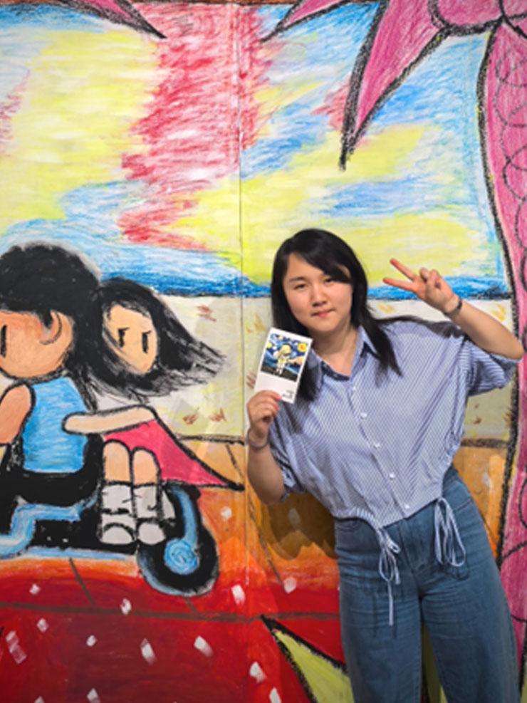 Woman smiling in front of a cartoon background