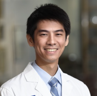 man with short black hair smiling