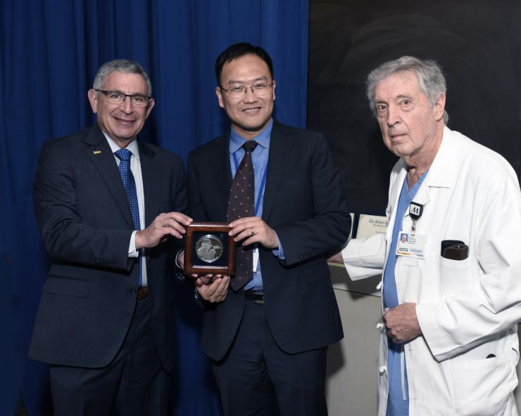 Dr. Xiang (Shawn) Zhang with Drs. Paul Klotman and George Noon.
