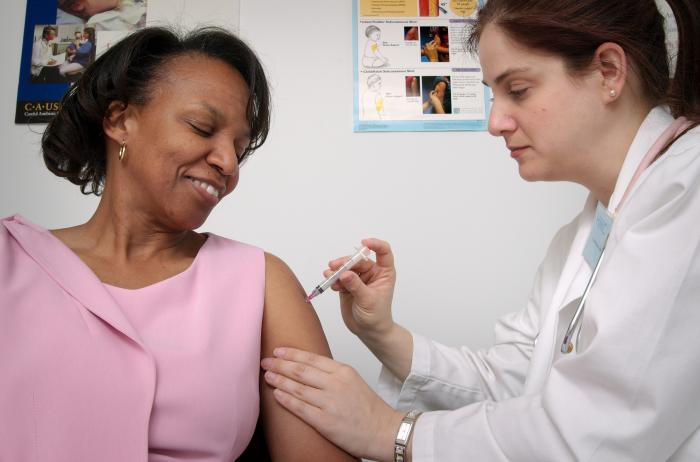 Woman receiving an intramuscular vaccine injection