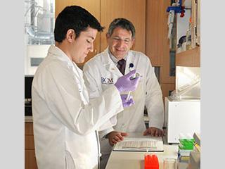 Dr. Paul Klotman with a colleague in the laboratory