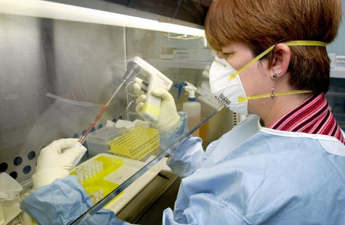 Researcher processing SARS specimens in a biocontainment facility