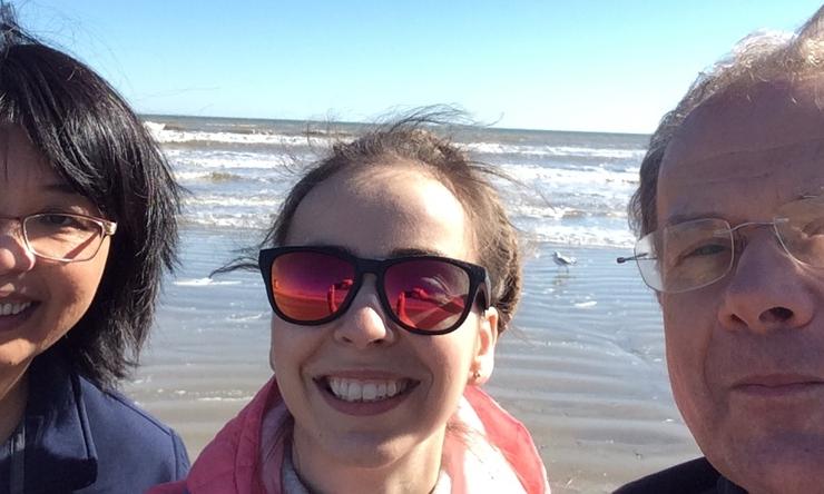 Qian Liu, Justyna Karolak and Prem Szafranski relaxing on the Galveston Beach after the 2019 department retreat.
