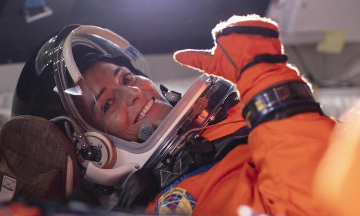 NASA astronaut Nicole Mann gives a thumbs up from inside the Orion spacecraft mockup.