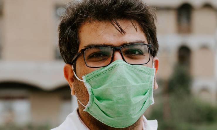 A frontline healthcare worker wearing a facemask