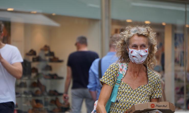 A person wearing a face mask in a mall.