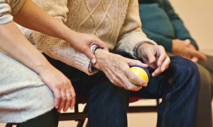 Elderly hands holding a ball