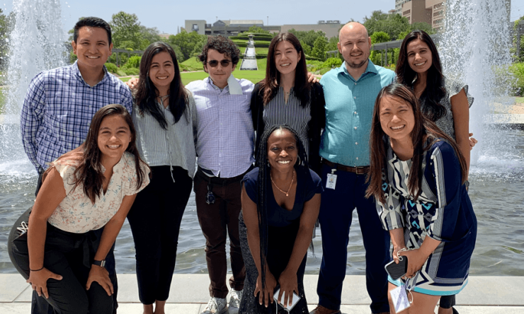 The Medicine-Pediatrics Class of 2026 pose in front of large water fountains in Houston's Centennial Gardens