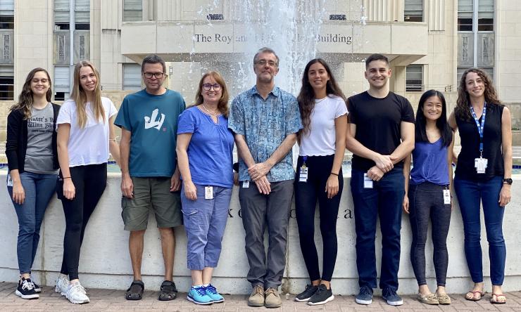 Lab photo 2021 at the BCM fountain. From left to right, Toni Martinez (Graduate Student), Katelin Hagstrom (Lab Technician), Alasdair Gordon (Staff Scientist), Jennifer Halliday (Assistant Professor), Christophe Herman (PI), Laura Deus (Graduate Student), Matthew Cooke (Graduate Student), Alice Wen (Graduate Student), Catherine Bradley (Graduate Student).